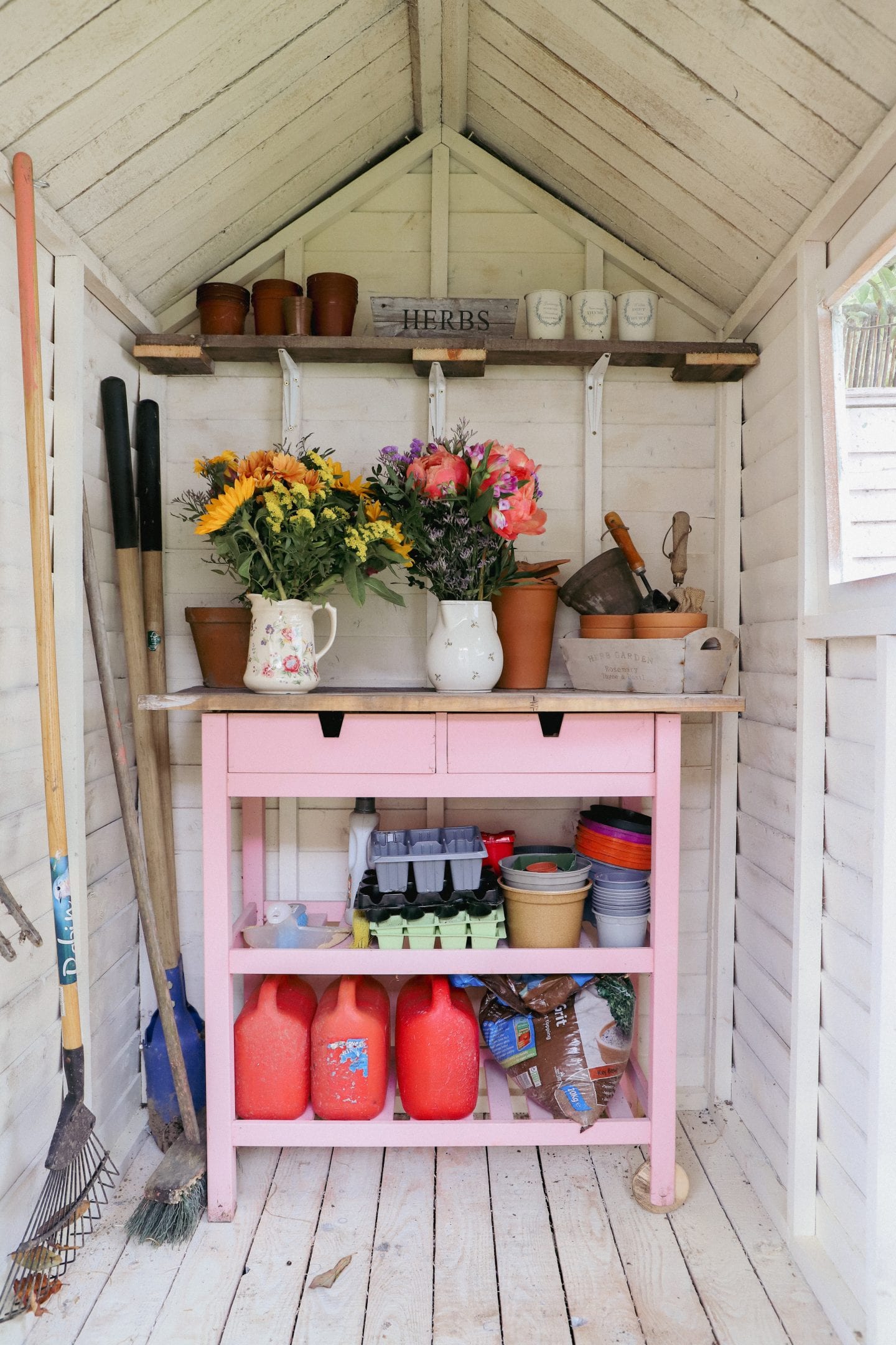 She shed makeover, white garden potting Sheed with Ikea cart.