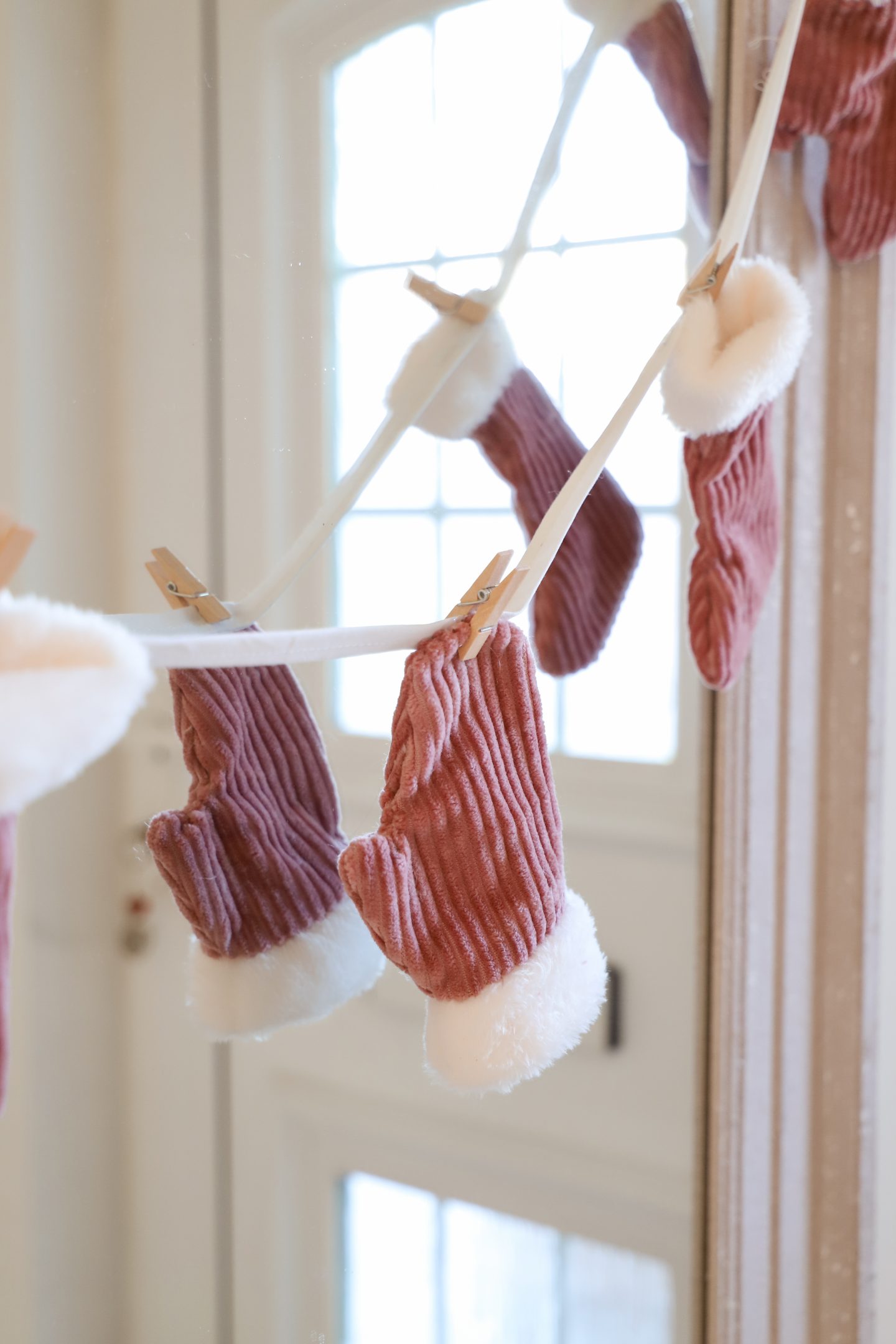 DIY mitten Christmas garland from pink recycled fabric.