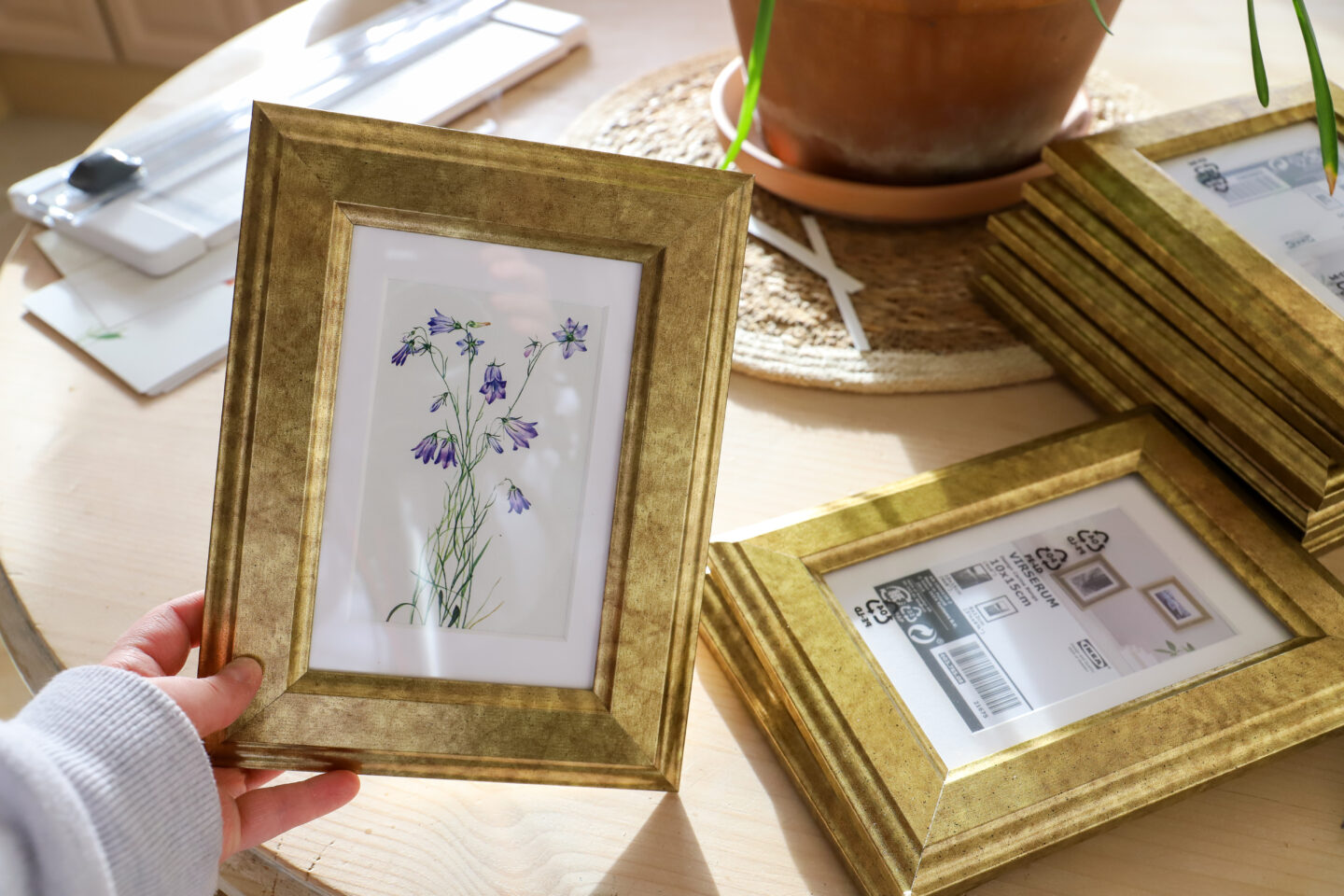 DIY gallery wall with gold frames floral prints.