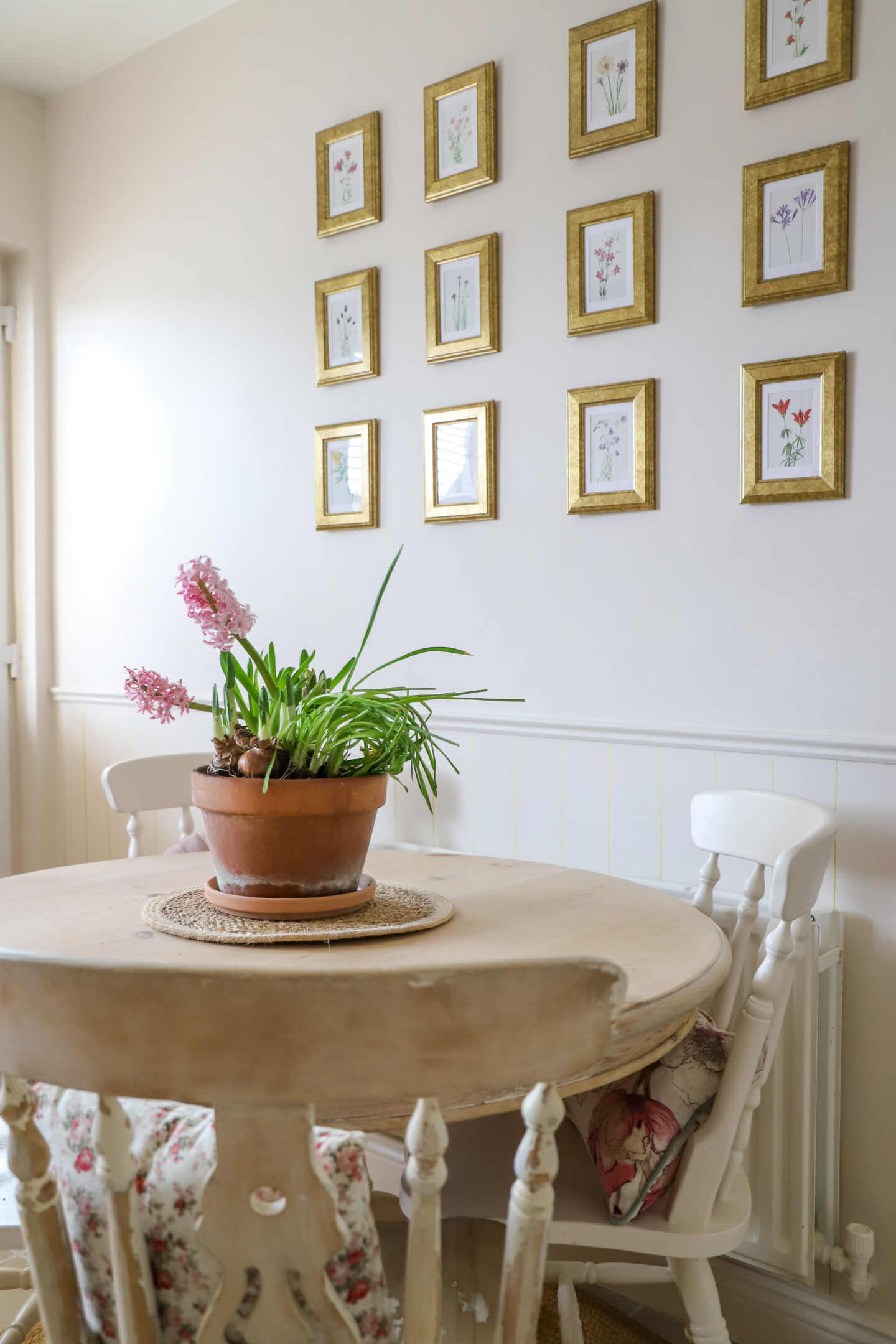 DIY gallery wall with gold Ikea frames floral prints.