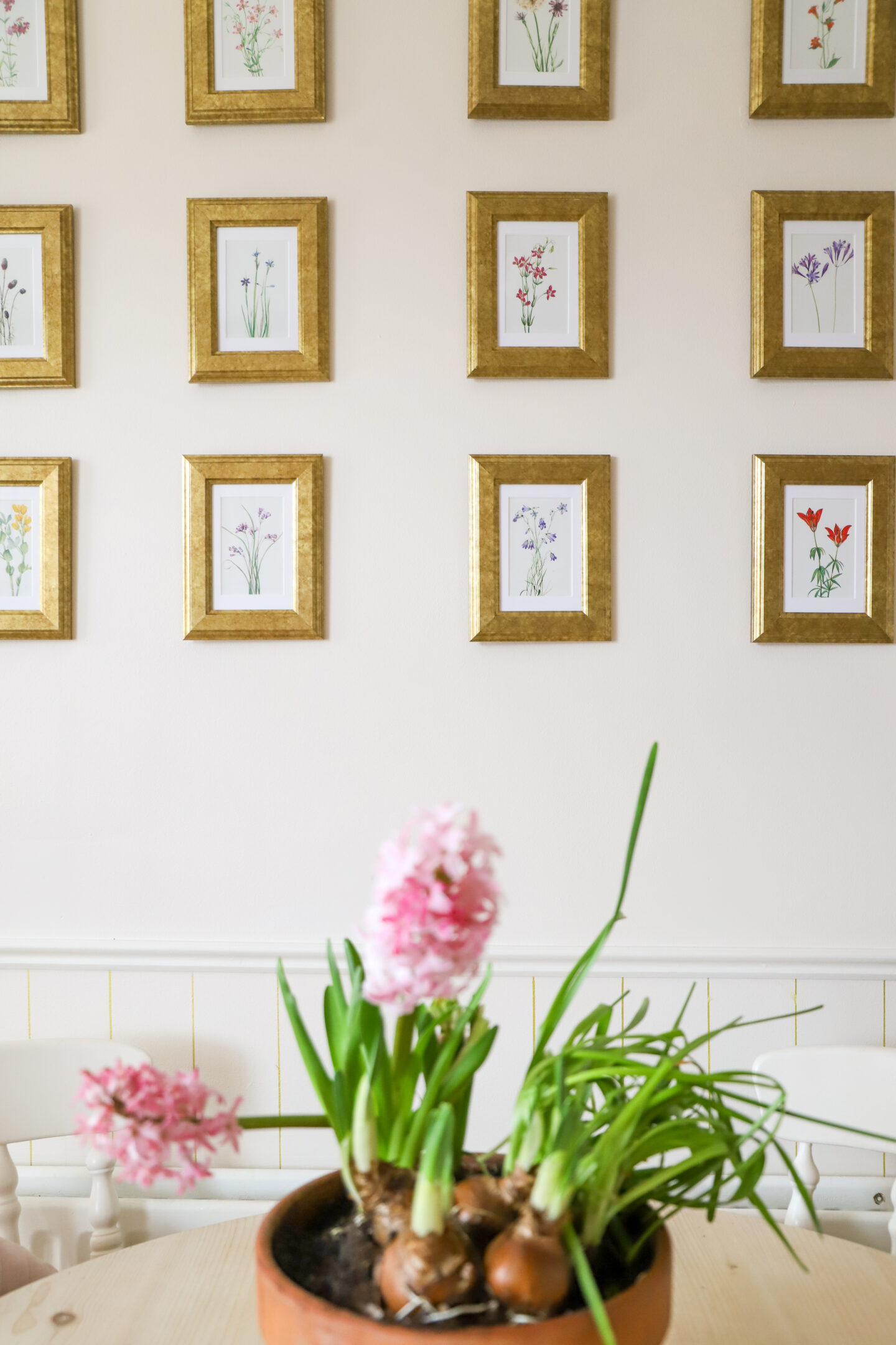 DIY gallery wall with gold Ikea frames floral prints.