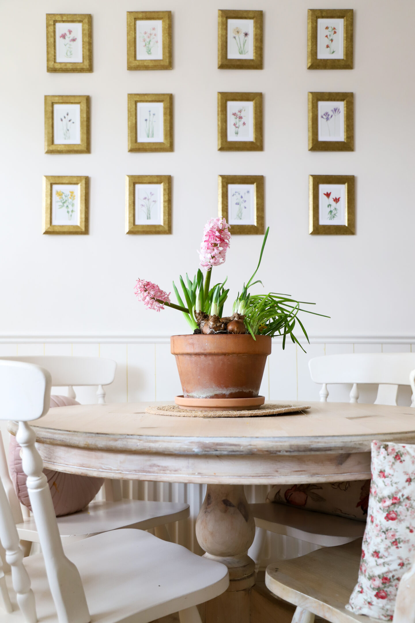 DIY gallery wall with gold Ikea frames floral prints.